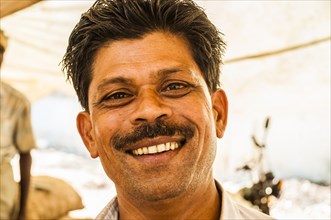 Laughing shopkeeper in a market