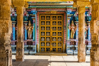 Colorful interior of Hindu temple with decorated door and pillars