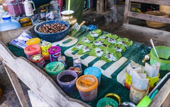 Market stall showing preparation of traditional chewing tobacco and betel nut