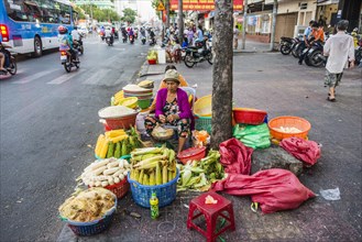 Woman selling vegetables by the roadside