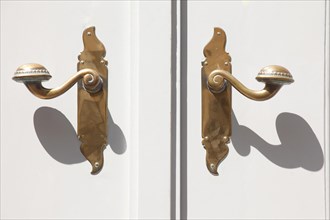 Old door handles on white door