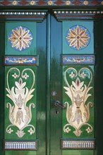 Reich-decorated and painted wooden door