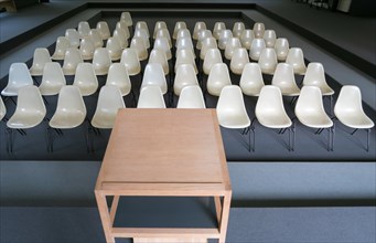 Empty chairs with desk in an auditorium