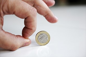 Hand rolls Greek euro away