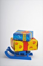 Colorfully wrapped gifts on a sledge