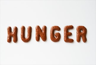 Hunger lettering written with alphabet biscuits