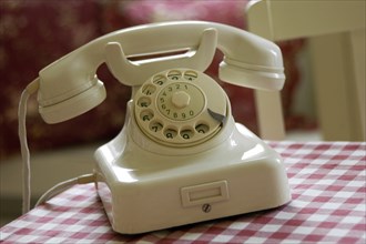 Historical white telephone with dial