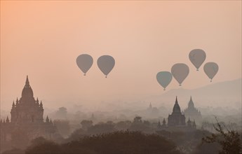 View of pagodas with hot air balloons