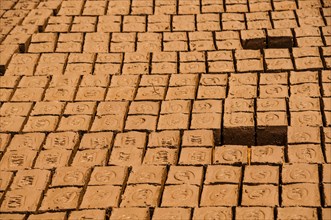 Red clay bricks laid out to dry