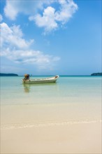 Motorboat on idyllic sandy beach