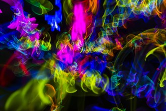 Colorful lights from glow sticks at a dark party using long exposure ight effect