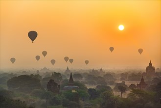 View of pagodas with hot air balloons