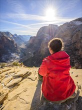 Young woman looking into the distance from Angels Landing to Zion Canyon