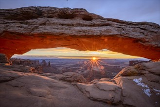 View through arch Mesa Arch at sunrise with sunstar
