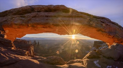 View through arch Mesa Arch at sunrise with sunstar