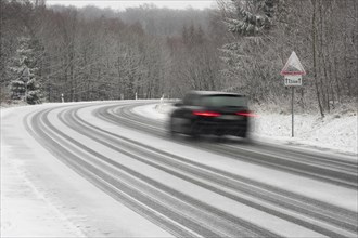 Car driving on snow-covered road