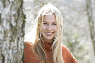 Portrait of a laughing young woman with long blond hair