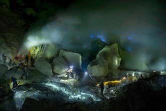 Workers in toxic sulfur mining in sulfur mine at night