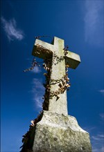 Anglican gravestone against a deep blue sky