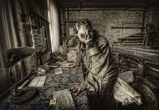 Man with a gas mask at his desk