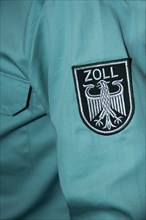 Emblem of German customs with eagle on a uniform shirt