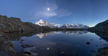 Moon and Mont Blanc reflected in the Lac des Chesery after sunset