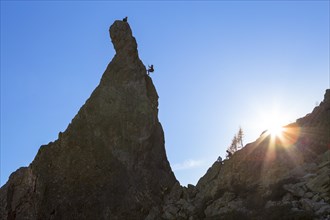 Climber abseiling off rocky pinnacle