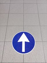 White directional arrow sign