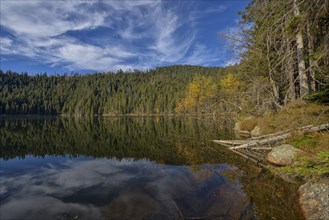 Reflection with clouds in Certovo jezero lake in fall