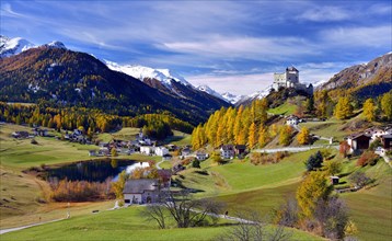 Castle Tarasp and mountain village Fontana in autumn