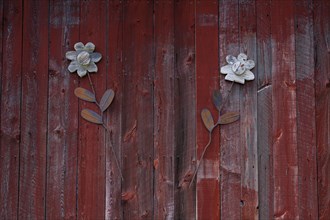 Decorative flowers on red barn door