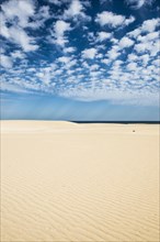 Dunes against blue sea