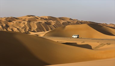 Road with car in the desert near Al Hamaim