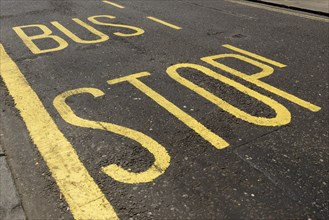 Lettering on road at bus stop