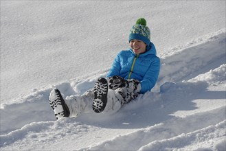 Boy on a minibob in deep snow