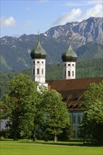 Benediktbeuern Abbey against Benediktenwand mountain ridge