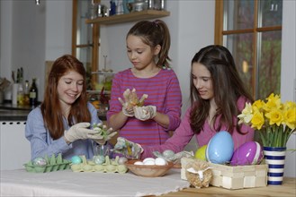 Girls colouring Easter eggs for Easter