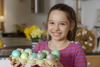 Girl with coloured Easter eggs for the Easter basket