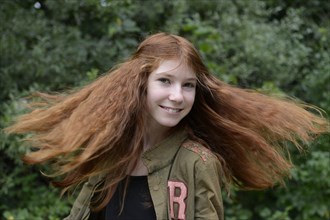 Teenage girl with long red hair