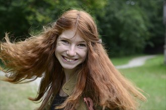 Teenage girl with long red hair