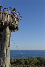 Girl standing on lookout tower at Cape Kamenjak