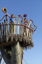 Boy and girl standing on lookout tower at Cape Kamenjak