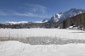 Frozen lake Lautersee in front of Karwendel Mountains