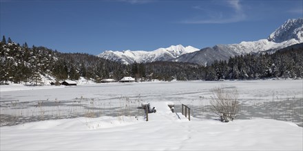 Frozen lake Lautersee in front of Karwendel Mountains