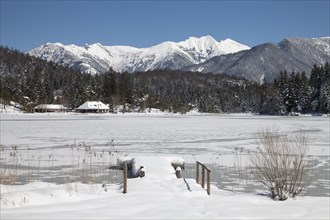 Frozen lake Lautersee in front of Karwendel Mountains