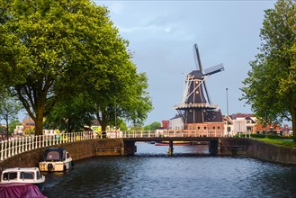 Windmill above a bridge and a canal