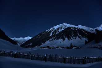 Farming village at night with starry sky in winter