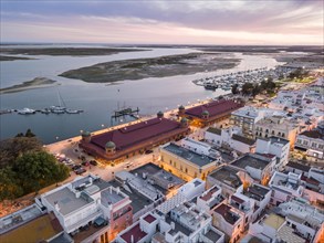 City view with two market buildings and and river Ria Formosa in the evening