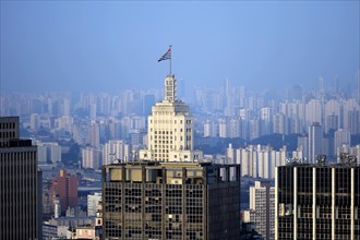 Skyscraper Edificio Banespa with flag of the state of Sao Paulo against cityscape with skyscrapers