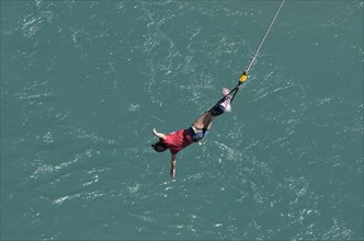 Bungee jumper on the rope over Kawarau River